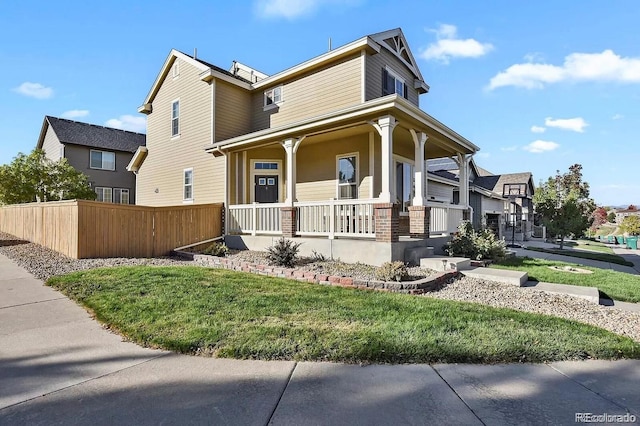 view of side of property with a yard and covered porch