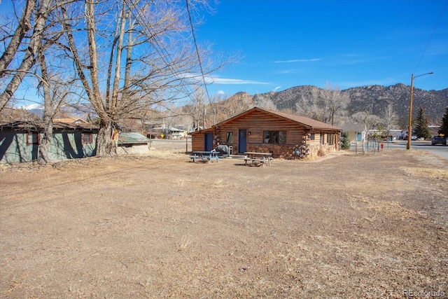 exterior space featuring log exterior and a mountain view