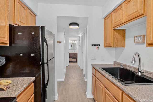 14934 E Hampden Cir Unit 3, Aurora, CO 80014 - kitchen featuring freestanding refrigerator, light wood-style flooring, and light stone counters
