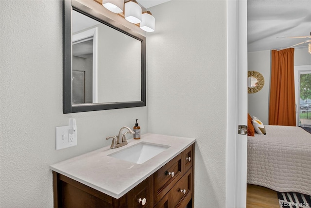 14934 E Hampden Cir Unit 3, Aurora, CO 80014 - bathroom with vanity, a ceiling fan, and a textured wall