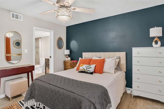 14934 E Hampden Cir Unit 3, Aurora, CO 80014 - bedroom with wood finished floors, ensuite bath, and ceiling fan