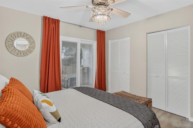 14934 E Hampden Cir Unit 3, Aurora, CO 80014 - bedroom with multiple closets, light wood finished floors, and a ceiling fan