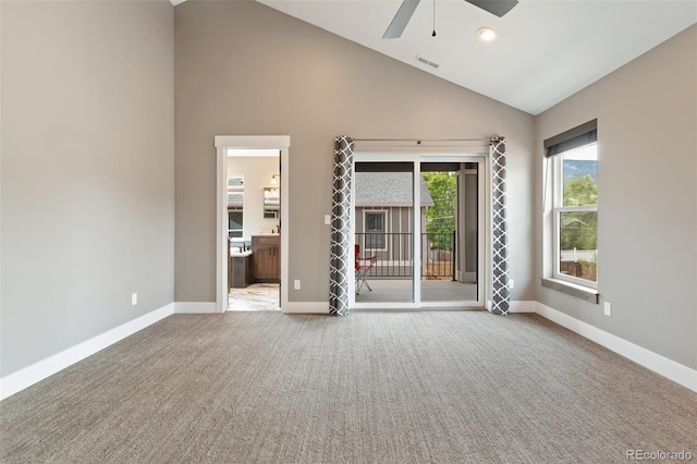 spare room with ceiling fan, carpet, and high vaulted ceiling