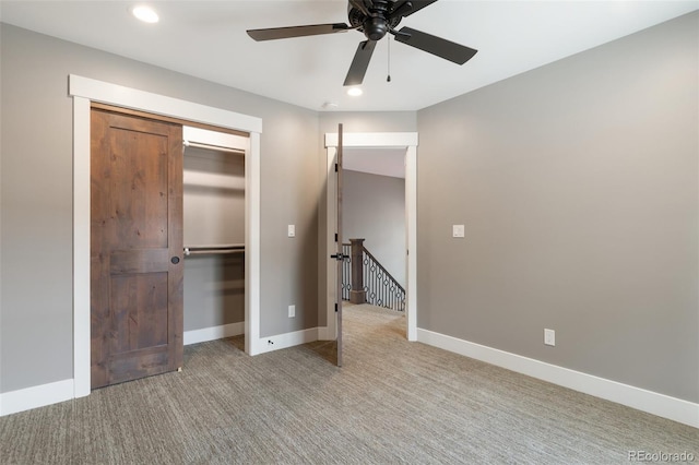 unfurnished bedroom with light carpet, a closet, and ceiling fan