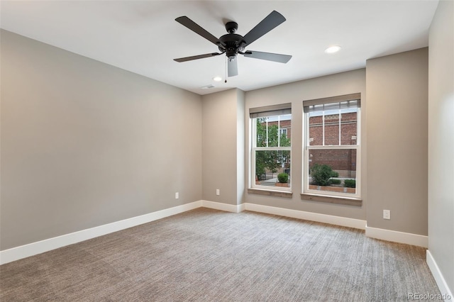 empty room with ceiling fan and carpet