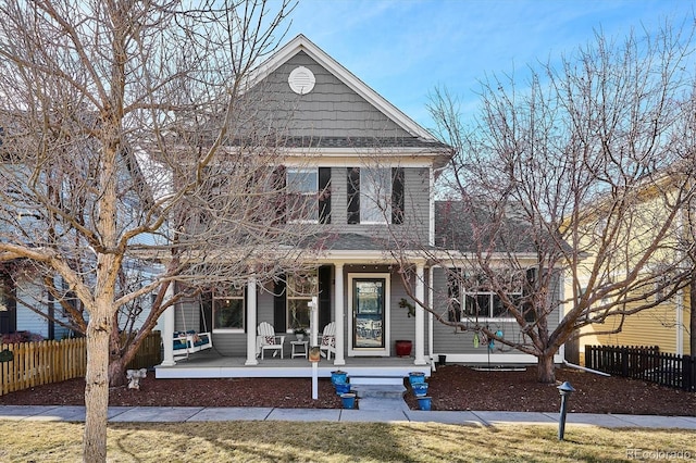 view of front of house with covered porch and fence