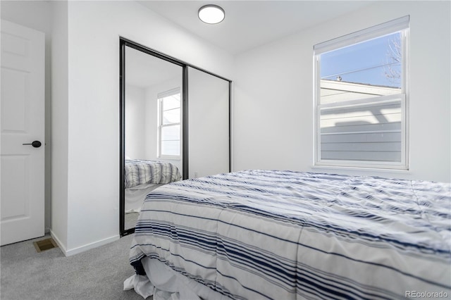 bedroom with carpet floors and a closet