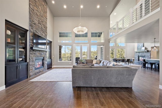 1803 Avenida Del Sol, Castle Rock, CO 80104 - living room with a fireplace, a towering ceiling, dark wood-type flooring, and recessed lighting