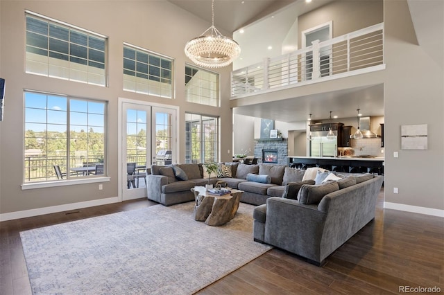 1803 Avenida Del Sol, Castle Rock, CO 80104 - living room featuring a towering ceiling, dark wood finished floors, plenty of natural light, and a chandelier