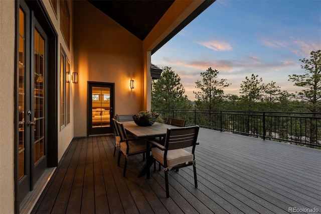 1803 Avenida Del Sol, Castle Rock, CO 80104 - deck at dusk featuring outdoor dining area and french doors