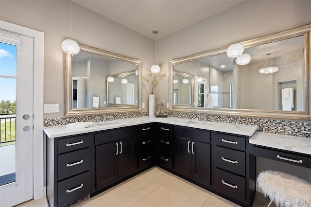 1803 Avenida Del Sol, Castle Rock, CO 80104 - bathroom featuring healthy amount of natural light, double vanity, backsplash, and tile patterned flooring