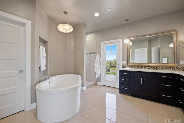 1803 Avenida Del Sol, Castle Rock, CO 80104 - bathroom featuring vanity, a freestanding tub, tiled shower, and tile patterned flooring