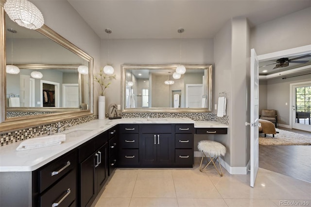 1803 Avenida Del Sol, Castle Rock, CO 80104 - ensuite bathroom featuring double vanity, backsplash, tile patterned floors, and ceiling fan