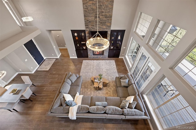 1803 Avenida Del Sol, Castle Rock, CO 80104 - living room featuring a towering ceiling, wood finished floors, and a fireplace