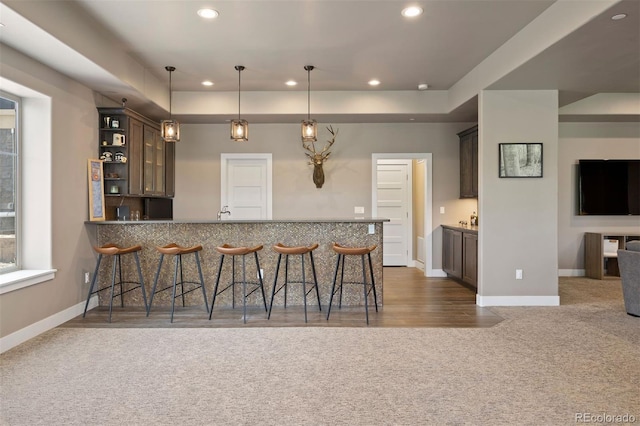 1803 Avenida Del Sol, Castle Rock, CO 80104 - kitchen with a kitchen breakfast bar, carpet flooring, recessed lighting, a peninsula, and pendant lighting