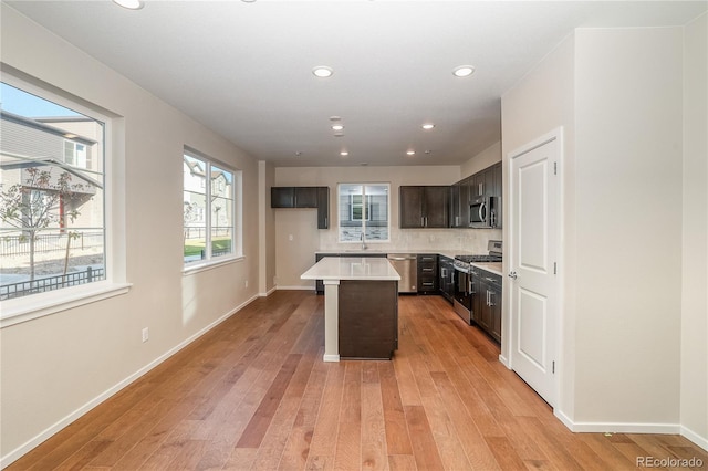 23931 E 40th Ave, Aurora, CO 80019 - kitchen with appliances with stainless steel finishes, a center island, light wood-type flooring, light countertops, and recessed lighting