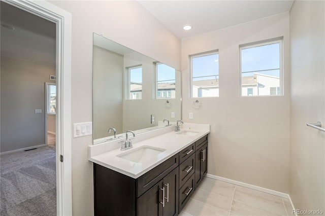 23931 E 40th Ave, Aurora, CO 80019 - bathroom featuring double vanity and baseboards