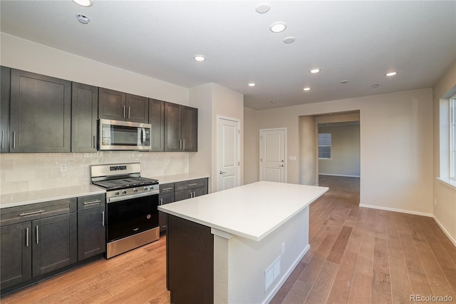 23931 E 40th Ave, Aurora, CO 80019 - kitchen featuring appliances with stainless steel finishes, light wood-style flooring, light countertops, recessed lighting, and tasteful backsplash