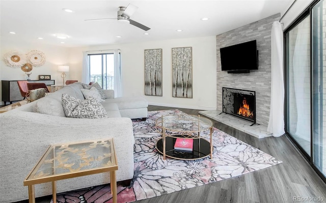 800 Pearl St Unit 1010, Denver, CO 80203 - living area with wood finished floors, a large fireplace, a ceiling fan, and recessed lighting