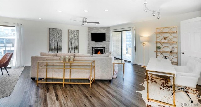 800 Pearl St Unit 1010, Denver, CO 80203 - living area with ceiling fan, dark wood-style floors, a stone fireplace, and recessed lighting