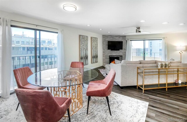 800 Pearl St Unit 1010, Denver, CO 80203 - dining space featuring wood finished floors, recessed lighting, a stone fireplace, and ceiling fan