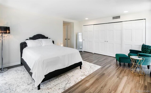 800 Pearl St Unit 1010, Denver, CO 80203 - bedroom featuring wood finished floors, recessed lighting, and a closet