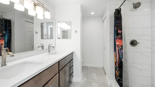 800 Pearl St Unit 1010, Denver, CO 80203 - bathroom with double vanity, curtained shower, and recessed lighting