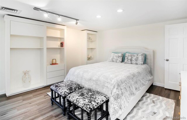 800 Pearl St Unit 1010, Denver, CO 80203 - bedroom featuring wood finished floors, recessed lighting, and rail lighting