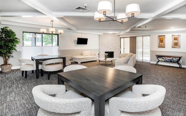 800 Pearl St Unit 1010, Denver, CO 80203 - dining space featuring coffered ceiling, carpet floors, a chandelier, beam ceiling, and a large fireplace