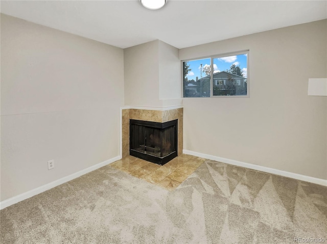 unfurnished living room with light carpet and a tile fireplace