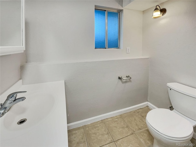 bathroom featuring tile patterned floors, toilet, and sink