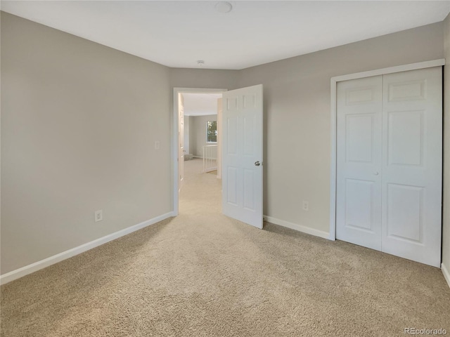 unfurnished bedroom with carpet flooring and a closet