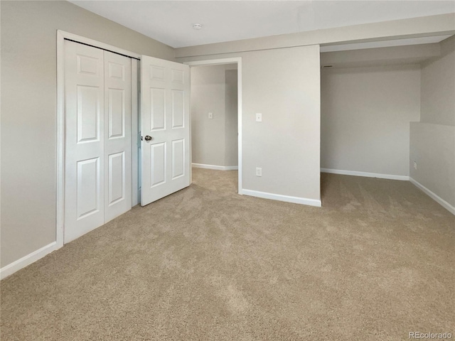 unfurnished bedroom featuring a closet and carpet floors