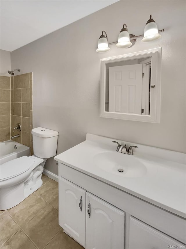 full bathroom with tile patterned flooring, vanity, tiled shower / bath combo, and toilet