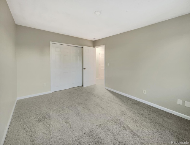 unfurnished bedroom with carpet and a closet