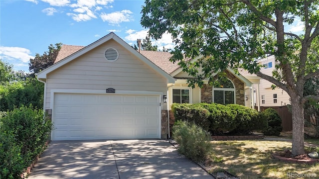3732 Rosewalk Ct, Highlands Ranch, CO 80129 - view of front of house featuring stone siding, concrete driveway, a shingled roof, and an attached garage