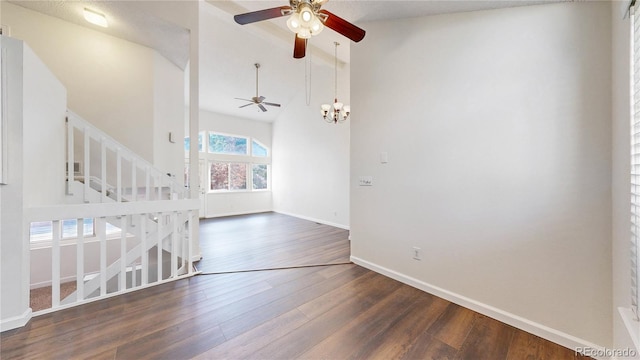 3732 Rosewalk Ct, Highlands Ranch, CO 80129 - empty room featuring a ceiling fan, vaulted ceiling, wood finished floors, a chandelier, and stairway