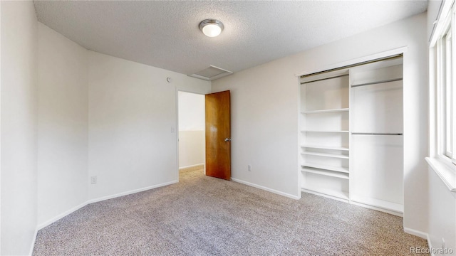 3732 Rosewalk Ct, Highlands Ranch, CO 80129 - unfurnished bedroom with carpet, a textured ceiling, attic access, and a closet