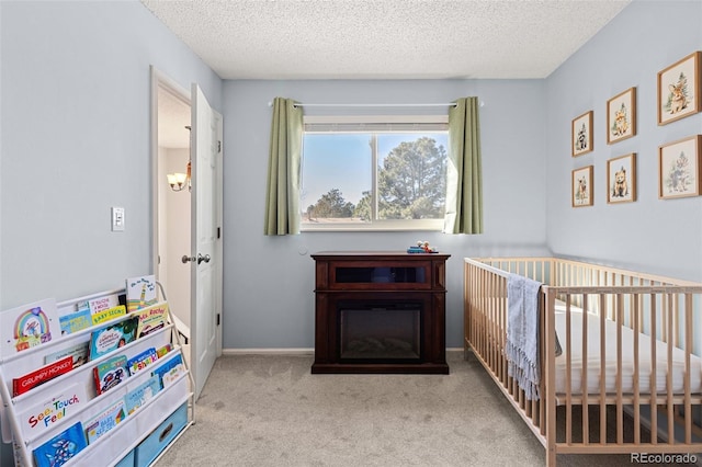 bedroom featuring carpet flooring, a textured ceiling, and a crib