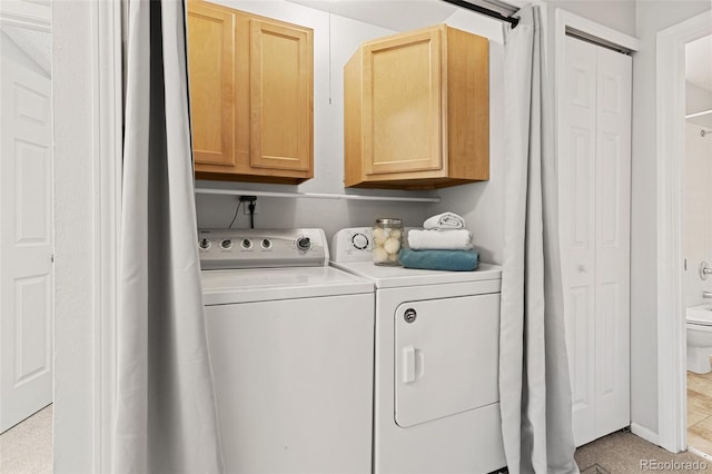 washroom featuring cabinet space and independent washer and dryer