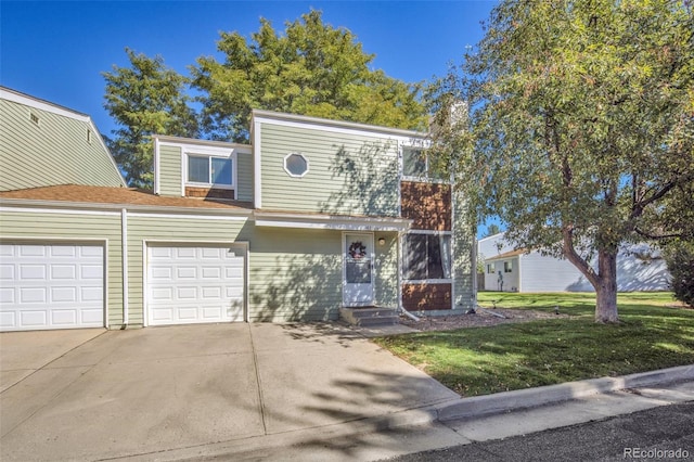 view of property with entry steps, a front yard, concrete driveway, and a garage