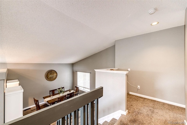 8930 Apache Plume Dr, Parker, CO 80134 - corridor featuring an upstairs landing, lofted ceiling, a textured ceiling, carpet floors, and recessed lighting