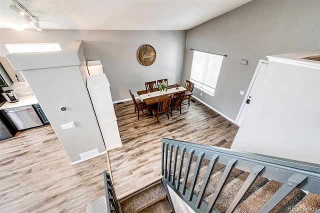 8930 Apache Plume Dr, Parker, CO 80134 - stairway with vaulted ceiling, wood finished floors, and track lighting