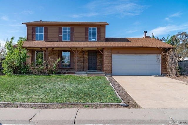 traditional-style home featuring an attached garage, concrete driveway, brick siding, and a front yard