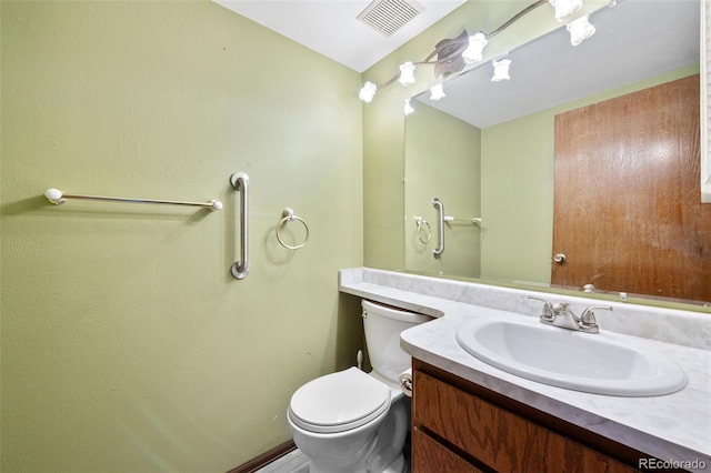 half bathroom with toilet and vanity