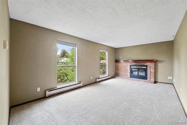 unfurnished living room with a baseboard radiator, carpet, a fireplace, a textured ceiling, and baseboards