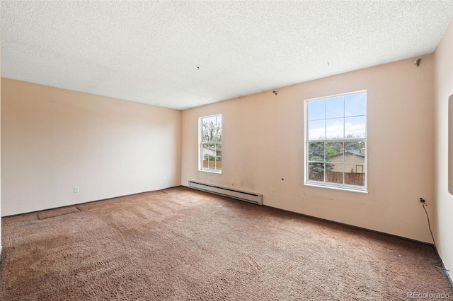 carpeted empty room with a baseboard heating unit and a textured ceiling