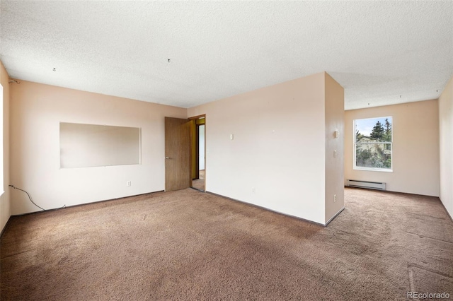 carpeted empty room featuring baseboard heating and a textured ceiling