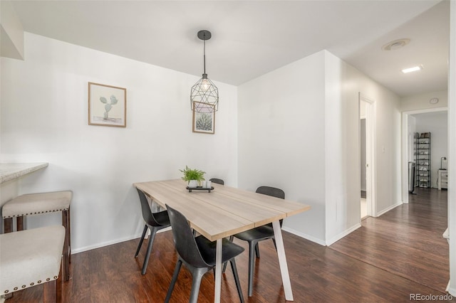 dining room featuring wood finished floors and baseboards