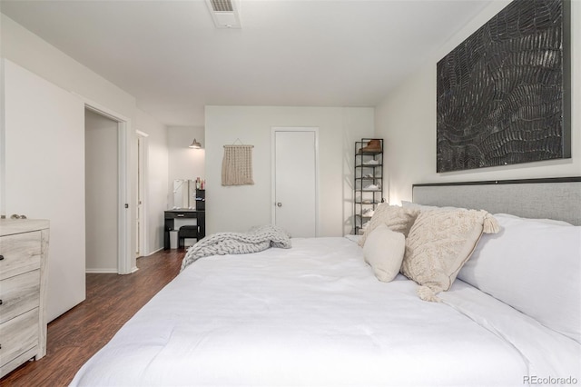 bedroom featuring visible vents and dark wood-type flooring